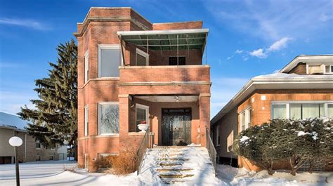 a house with snow on the ground and steps leading up to it