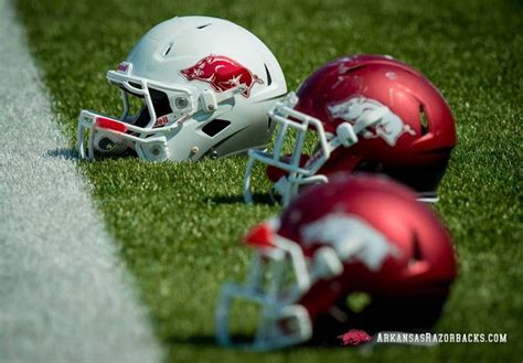 two football helmets sitting on top of a field