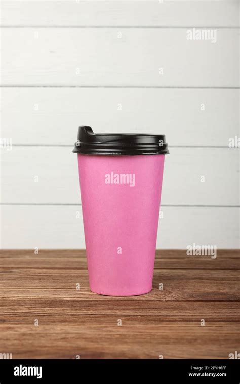 Pink paper coffee cup over white wall Stock Photo - Alamy