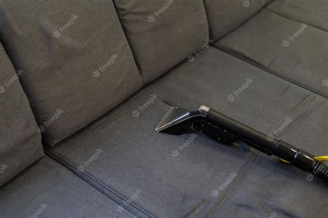 Premium Photo | Cleaning sofa with vacuum cleaner