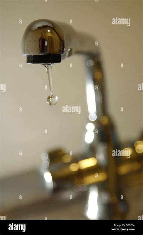 A tap with running water Stock Photo - Alamy