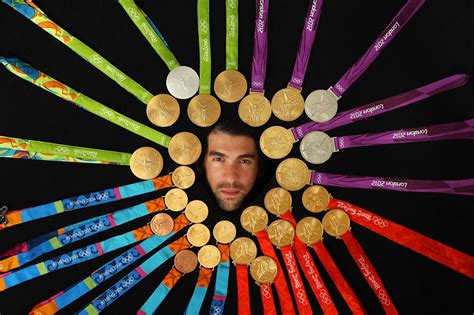 Michael Phelps poses with all 28 of his Olympic medals, 23 of them gold ...