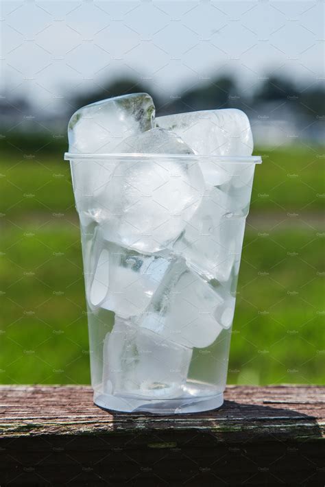 Plastic Cup full of ice outdoor | Food Images ~ Creative Market