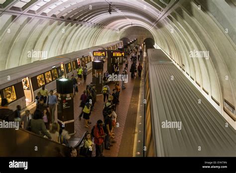 DC Metro subway trains at the platform of the Bethesda, MD station. Many passengers are visible ...