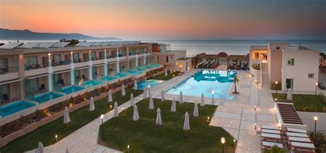 an aerial view of the resort and pool at dusk