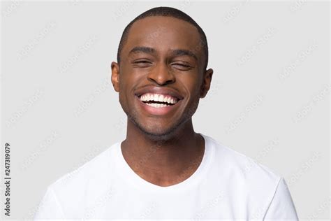 Cheerful happy african millennial man laughing looking at camera ...