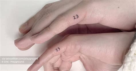 Matching tattoo of the number "23" for couple.