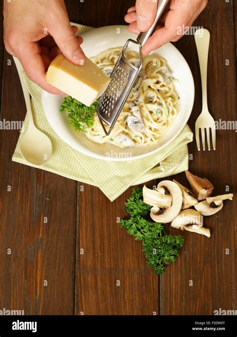 Chef grate parmesan cheese on pasta carbonara, top view Stock Photo - Alamy