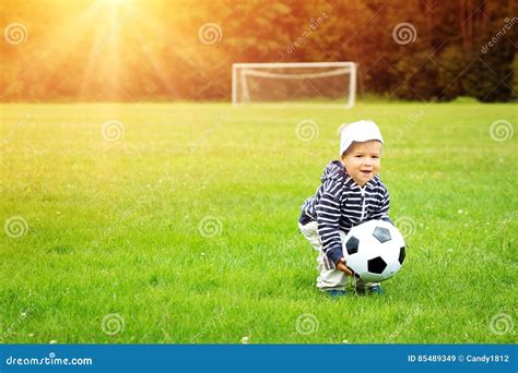 Little Boy Playing Football on the Field with Gates Stock Image - Image ...