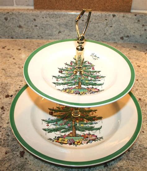 two plates stacked on top of each other with a christmas tree painted on the bottom