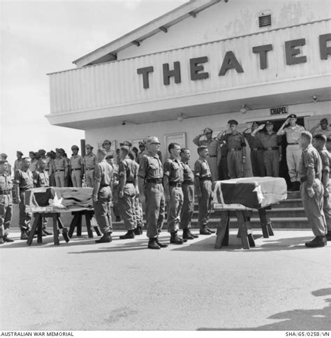 PALL BEARERS STAND NEAR THE COFFINS DRAPED WITH THE AUSTRALIAN FLAG DURING THE FUNERAL SERVICE ...