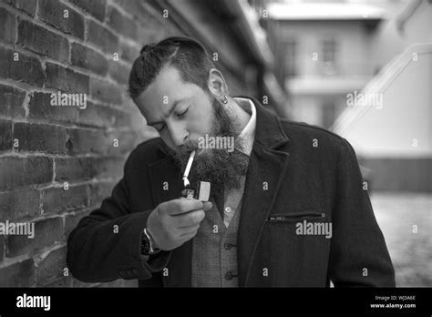 Handsome man smoking cigarette Black and White Stock Photos & Images - Alamy