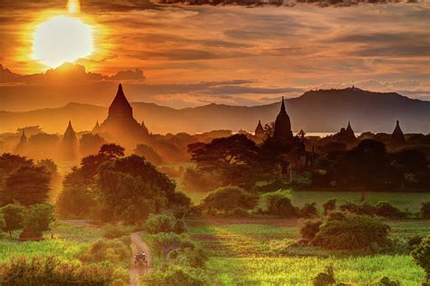 Sunset over Bagan Temples and green fields in Myanmar Photograph by Jecky Bershteyn - Pixels