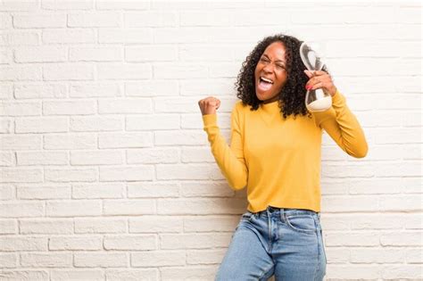 Premium Photo | Young black woman celebrating a victory or success