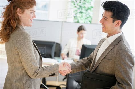 Business people shaking hands in office - Stock Photo - Dissolve