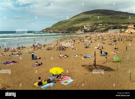 Crowd of people sunbathing on the beach Arena Bilbao, Spain Stock Photo ...