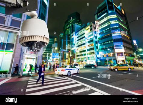 CCTV Camera or surveillance operating on street and building at night ...