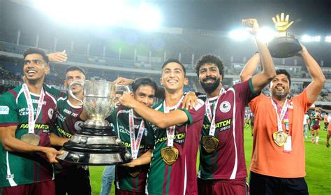 Mohun Bagan Super Giant players pose for photos with the trophy after ...