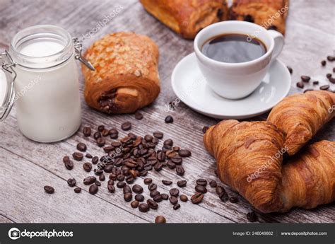 Coffee and croissant for breakfast on rustic wooden table Stock Photo ...