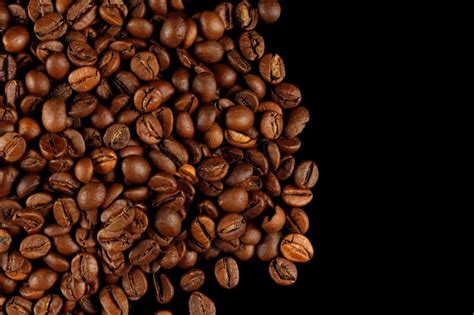 Premium Photo | Coffee beans on a black background