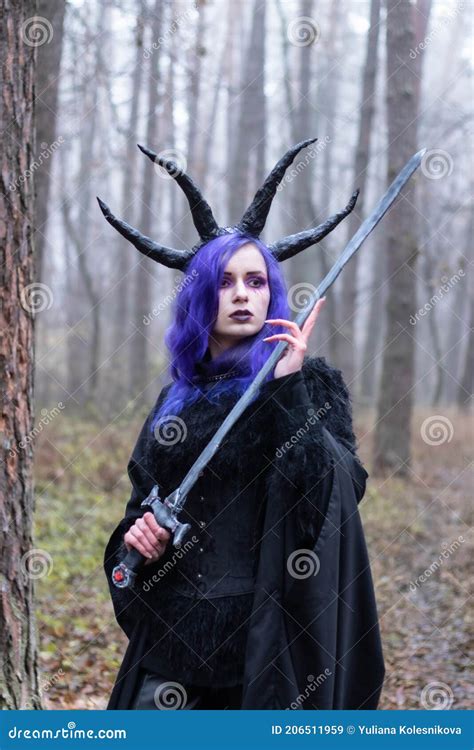 Demon Girl with Halloween Makeup and Purple Hair Holding Sword Stock ...