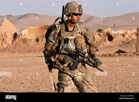 A US Army soldier on combat patrol in a village August 18, 2014 in ...