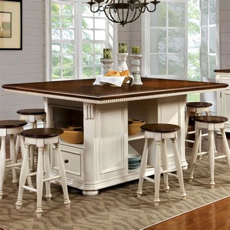 a kitchen island with stools and a chandelier