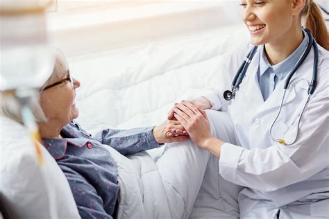 Smiling patient keeping hand of doctor | Virginia Women's Center