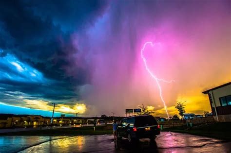 See electrifying moment pink lightning bolt strikes Earth after snapper captures storm on camera ...