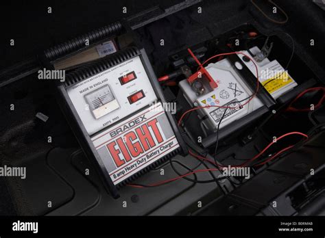 Car battery charger charges a flat 12v car battery in a BMW Z4 car ...