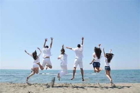 happy people group have fun and running on beach 12641179 Stock Photo at Vecteezy