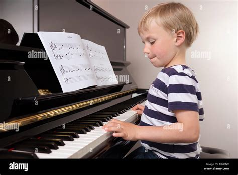 Child playing piano hi-res stock photography and images - Alamy