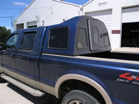 a blue pick up truck parked in front of a building