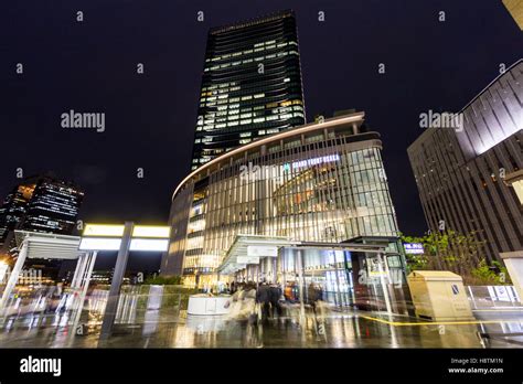 Japan, Osaka Station City. Covered walkway to Grand Front Osaka building from the station. Night ...