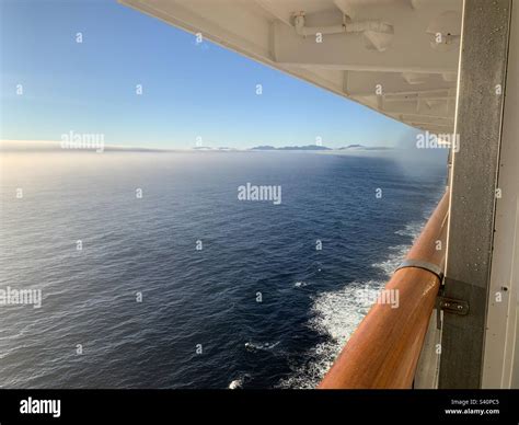 Steam fog rising from the water in Southeast Alaska, viewed from a ...