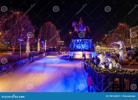 Night Scenery at Ice Rink with People Enjoy Ice Skating at Heumarkt, Famous Christmas Market ...