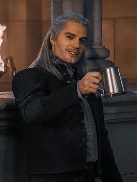 a man with grey hair holding a coffee cup