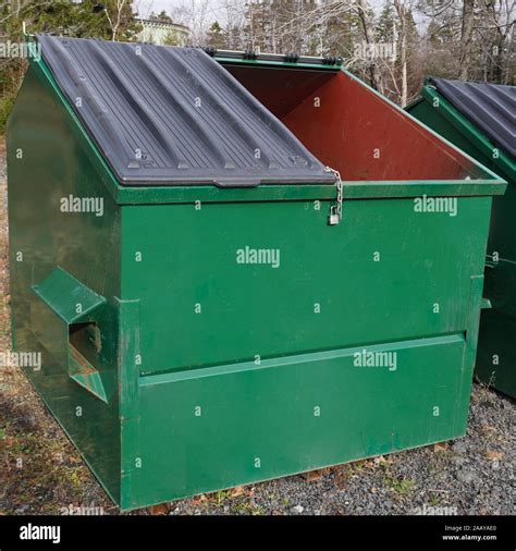 Large green commercial garbage bin with one side lid eft open Stock Photo - Alamy