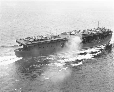 USS Long Island (ACV-1) underway with a mixed cargo of airplanes and stores on her flight deck ...