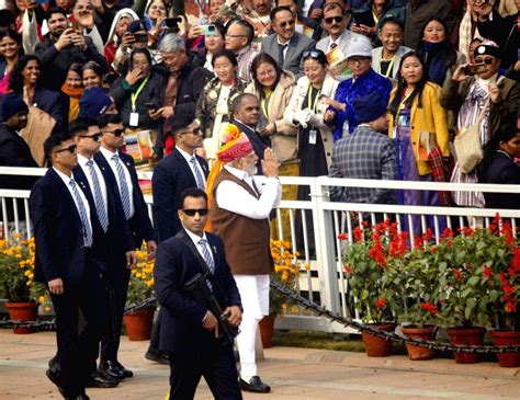 Prime Minister Narendra Modi acknowledges the crowd as he leaves after the 75th Republic Day ...