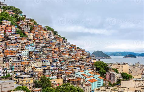 Brazilian favelas on the hill with city downtown below at the tropical ...