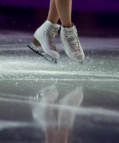 Ice flies away from the skates of Mao Asada of Japan as she performs during the exhibition of ...