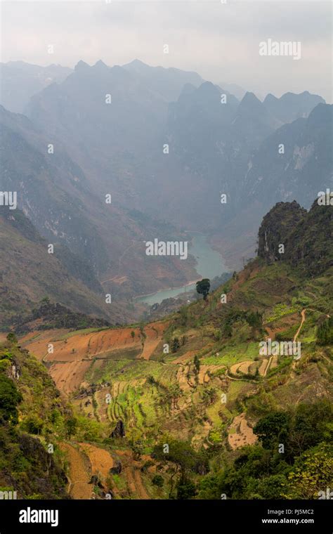 Ha Giang, Vietnam - March 18, 2018: Rice terraces, mountains and lake seen from Ma Pi Leng peak ...