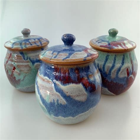 S Jars set Different coloured lids £60 | Canterbury Pottery