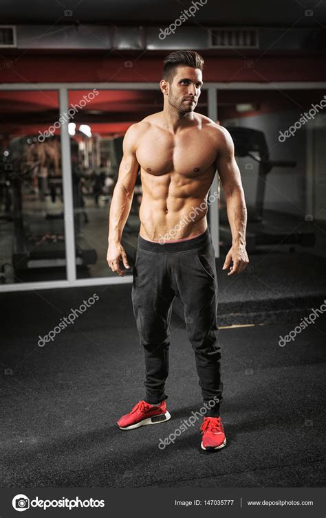 Fit man working out at gym Stock Photo by ©dusanpetkovic 147035777