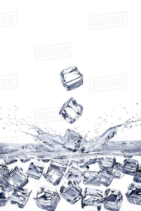 Falling ice cubes splashing into water and floating - Stock Photo ...