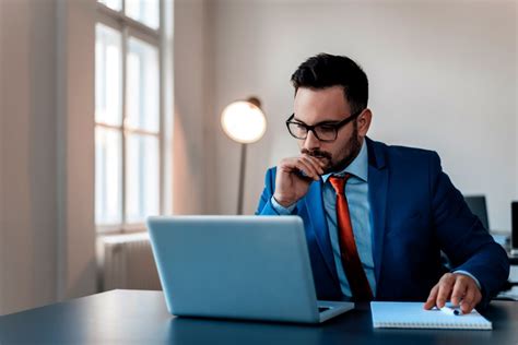 thoughtful-businessman-in-office-working-on-laptop-picture-id909203328 | AvePoint Blog