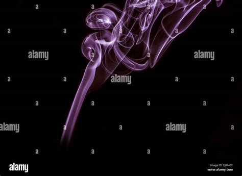 Purple smoke art against the black background Stock Photo - Alamy