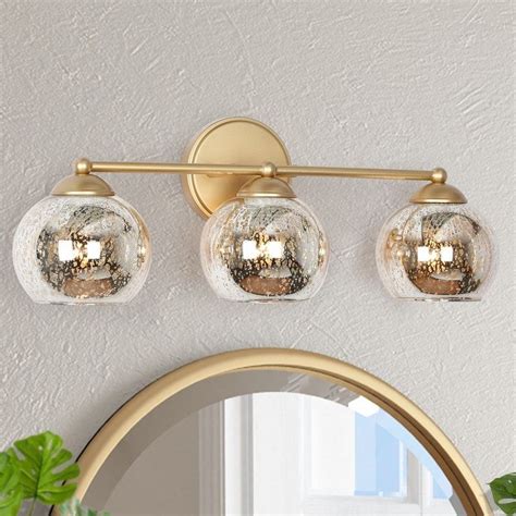 This 3-light gold bathroom light with mercury-polished glass shades casts a charm splendid glow ...