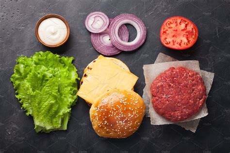 Hamburger building kit fresh ingredients for burger on dark stone table top | Food Images ...